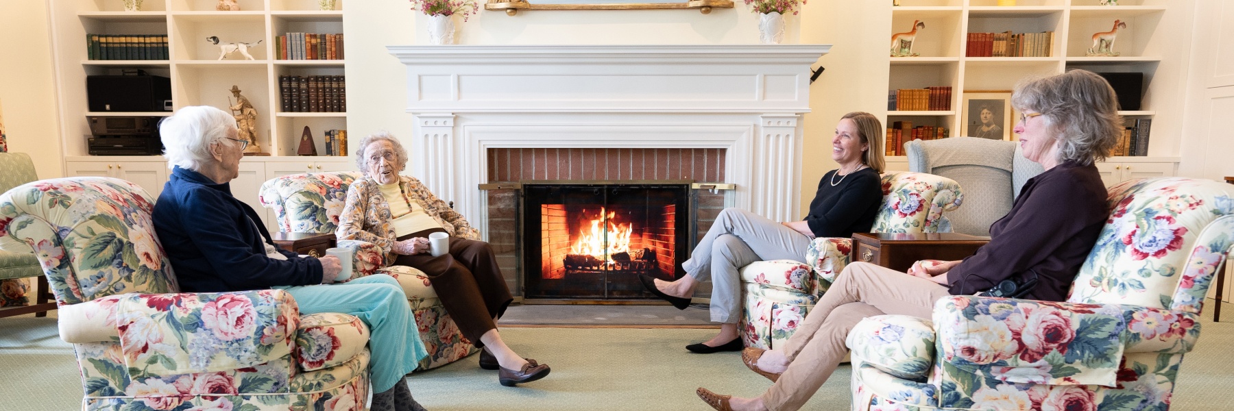 A cozy scene of elderly individuals sitting in Clara Welch Thanksgiving Home, 48 Grove Street, Cooperstown New York